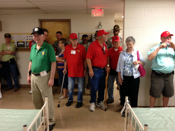 Reunion Photos - Jerry Orr
Touring the training barracks.  Ed Mahoney lets the old bunk beds bring back a smile of remembrance.
