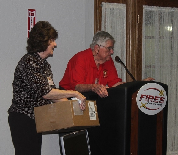 The Waldman Collection - Presenting Gifts
Host Jerry Orr did not forget the ladies who attended the reunion.  No sir, he did not.
Come and get your gifts.   Assisting Jerry is Barbara Mueller.
