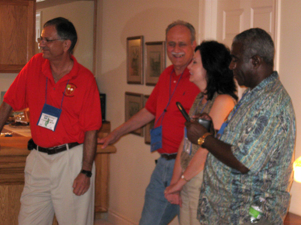 Watching the show
Tom Roman, Byron Kurtgis, wife Lisa, and Ernest Correia observe Dave Collins serving as master of ceremonies.
