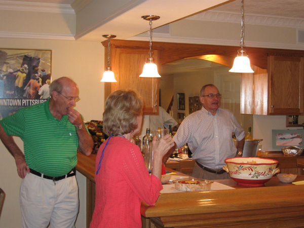 Tasting the goodies
Jim Beddingfield takes a big bite next to wife Linda.  Host Roy Hoffman stands behind the bar.
