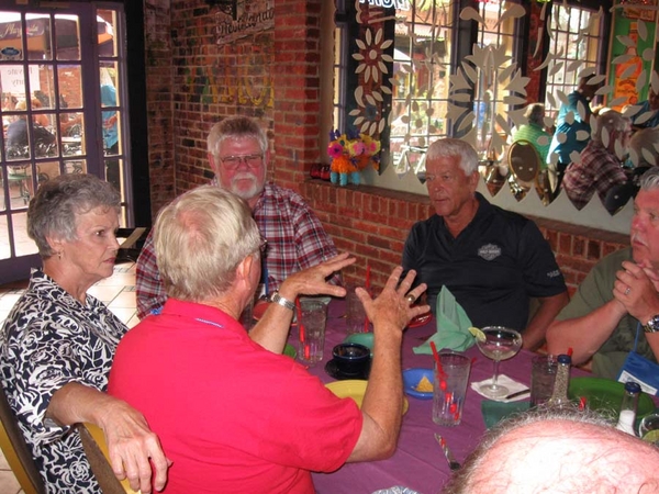 Party Time!  C-1-35 & 2/9th Arty at the LaMargarita
WOW!  Wife Alexis Munden (left) seems astounded by husband Dennis' telling of a war story.  Lt Gary Dean Springer (center) seems less impressed, while Lt FO Ed Thomas is mildly undecided.
