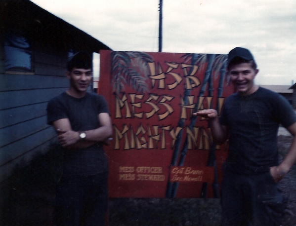 Hqs Service Battery, Mess Hall at Camp Enari
Sp5 John O. Olson and Sp4 Herb C. Banks admiring the sign.
