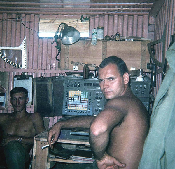 Inside the CONEX
Check this FDC out!  Lotsa cool memories.  Note the RDP fan at top left, a good look at the FADAC (center), a can of RISE shaving cream on the shelf, a standard GI flashlight clipped to the wall at right and a guy wondering (Dietrich) why you want to take his picture.   That's Geary Burrows in the background.
