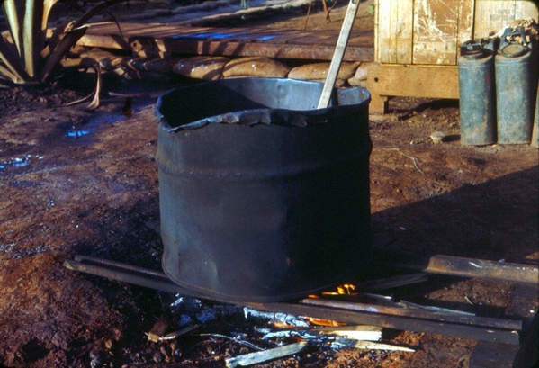 Wash-o-matic
Doing field laundry.  We used a similar method to burn the outhouse waste with diesel.   Hope it's not the same barrel.
