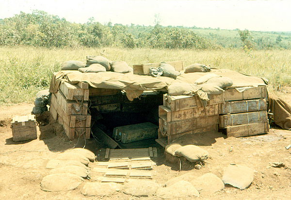 Makeshift Bunker
May not look pretty...but it's effective!  Ammo crates over a hole in the ground.  A quick fix.  Best if the ammo crates are empty.
