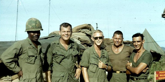 LZ OD - Command & Staff
Radar Officer Emil Franklin, Capt Mike Casp (KIA, Nov 67), Lt Dennis Munden, FCO, 1Sgt William Rollins, Lt Dennis Dauphin, XO.  "A" Battery, LZ OD
Sign says: "Practice Malaria Discipline"
