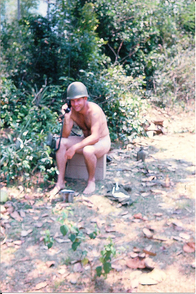 "Hey!  Where's that resupply chopper with the load of toilet paper?"

Note the proper use of headgear in the war zone.  Reflects that great training at OCS.
