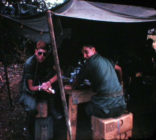 Chow Tent
Lt Chris Herrick and FO Lt Doug Turner at the chow tent.  Notice how Doug protects his share of the C-Rations.
