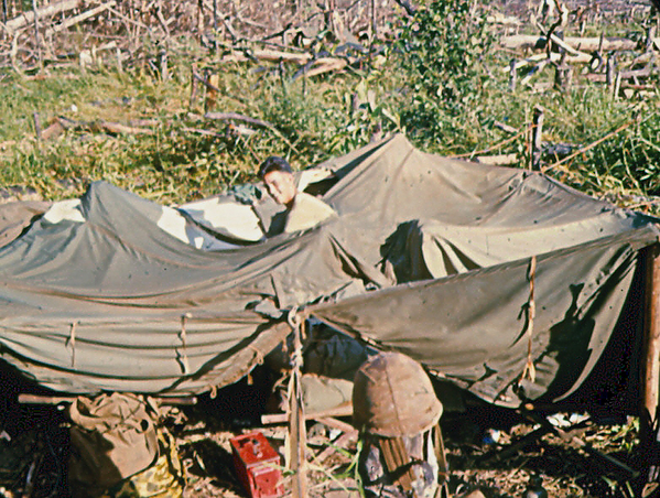 Chinook downdraft
Of course, there is a "price to pay" for the Chinook' services.  Those powerful blades will collapse any tent around.  Sp4 James Louk, FDC, is smiling at the same time he is pissed.
