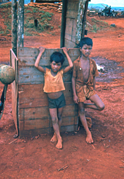 Plei Me
Two Montagnard boys stand in back of the "one-holer".
