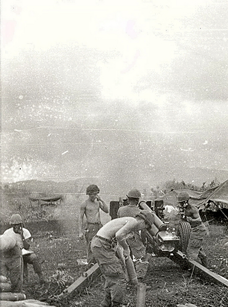 Fire!
The howitzer is fired.  Note the trails "dug in" to contain recoil.  Cannonerr in rear of the trails prepares another round for firing.
