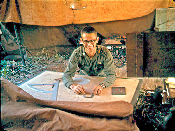 Firing Chart
FDO Lt Kermit DeVaughn looks up from his firing chart.  Note the RDP fan and map pins.  According to my diary, Lt DeVaughn was credited with convincing the BnCO, LtCol Holbrook, to try out the concept of two CONEX containers welded together to form a combat-ready Fire Direction Center (FDC).
