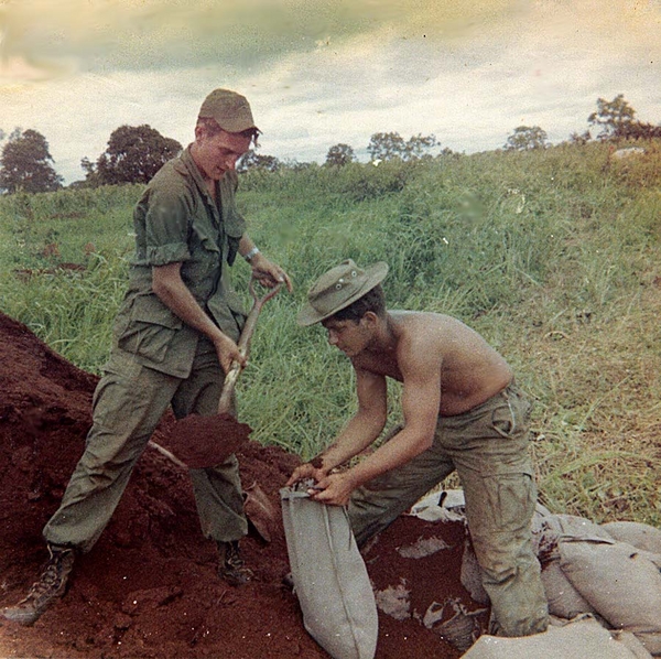 Best Defense
The best defense is a filled sandbag.  Sgt Goodrich holding the shovel and Sp4 Sternadel managing the bag.
