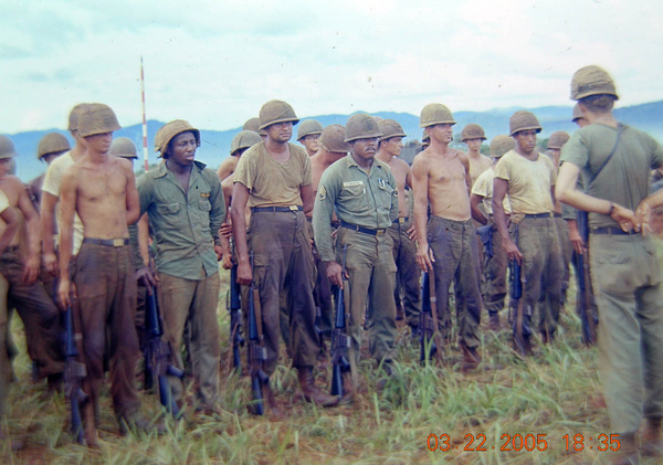 Looking more like a war zone now
Battery Commander Osborne has the troops in formation for a message.  Probably told them to bathe more often.  You can now see the glimmer and shine of stateside OD uniforms give way to continuous field duty.  Certainly not how we started out!
