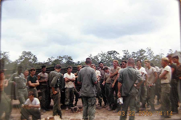 Mail Call
The greatest morale booster in all of Vietnam.  You stand around and wait for your name to be hollered out during Mail Call.  Battery Commander Frederick Rice holds a white Polaroid camera in his left hand during the mail call.
