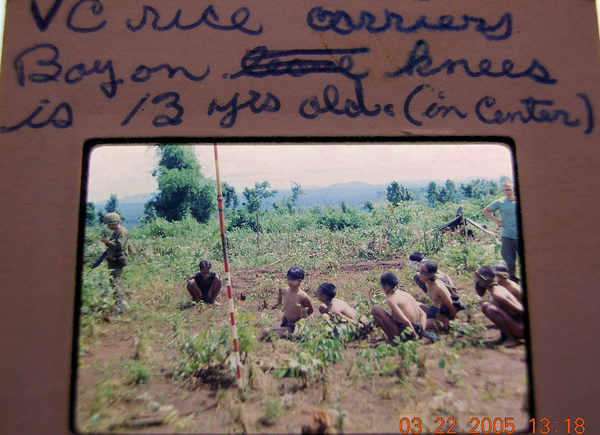 Captured rice carriers
Young prisoners.  They were told not to talk, but they are violating that order.  See "Tour of Duty - Memories" for the whole story.
