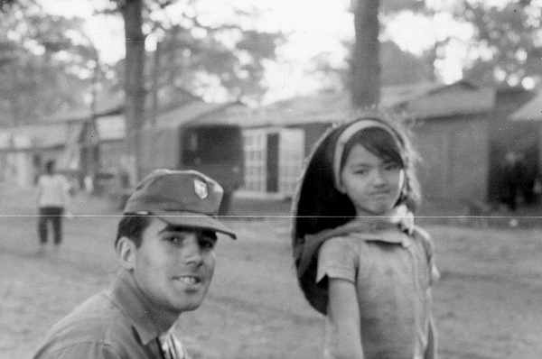 How do?
George Justice posing with a spunky little village girl.
