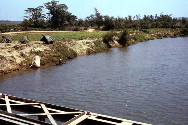 Land and water
Grunts occupy tents while Vietnamese fisherman occupies a boat near the bank.
