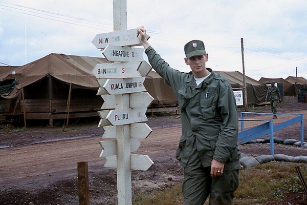 Signpost
It was typical to have a signpost in your duty area.  Everybody wanted to be someplace else.  Note the "soft cap" with the 2/9th Arty insignia.
