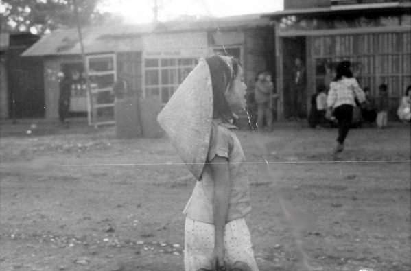 Mixed dress
She may be wearing western clothing, but the conical straw hat is all Vietnamese.
