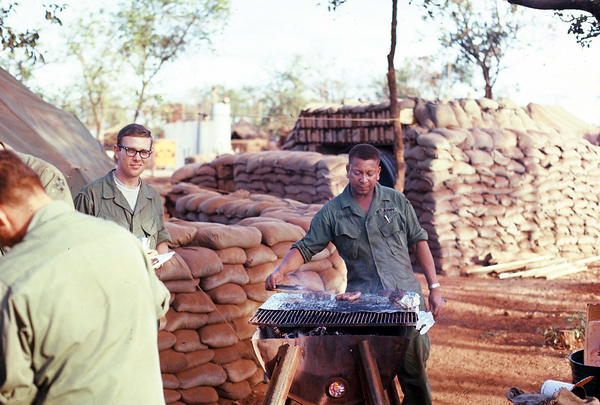 Come and get it!
MSgt Clayborn serves as the master chef for some good-looking chow.  Meanwhile, Floyd McKendree makes sure he is first in line.
