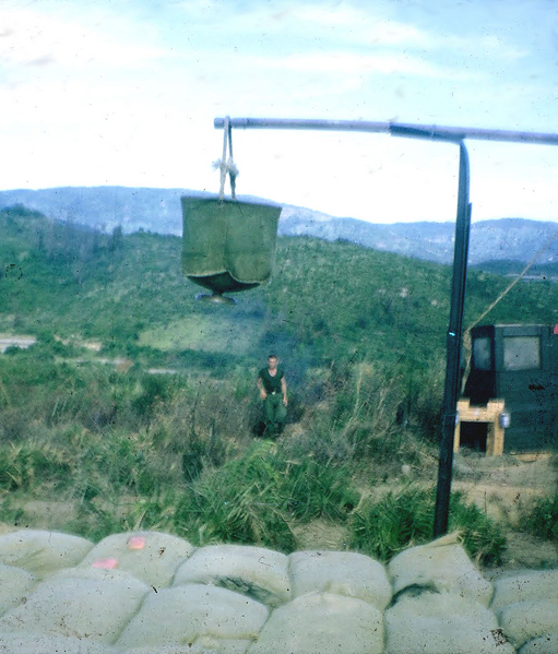 S*** & Shower
LZ OD had the advantage of more amenities than most firebases.  Note the shower in the foreground and a sheltered crapper in the background.  The view is from the SSG Holt's #6 gun pit.  The gun crews were constantly improving their positions.
