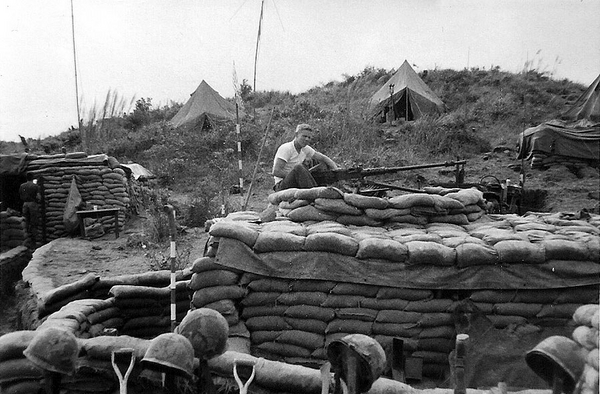 Lesson Learned
Never put a .50 cal machine gun on top of a bunker.  You have to rebuild the bunker.  PFC John Waldman test fires the 50-caliber and becomes part of the rebuilding crew.
