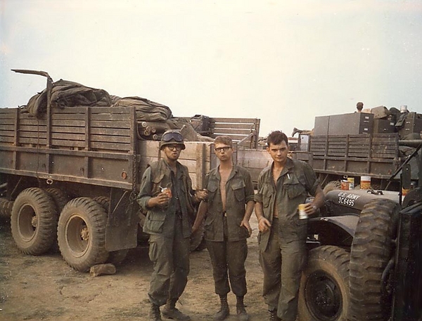 O Tannenbaum?
I'm on the left, Ken Fogel, middle, and at right was Zastrow, I recall. I believe he was shot on perimeter guard duty at Duc Pho, sent home and recovered later. A very likable fellow with a great sense of humor. I think he was from Wis/Minn area. I preferred to eat C's in the field- even often at Duc Pho/Montezuma. But in this case, somebody sent us canned goods from back home and we were FEASTING!  I got hit with something from a truck that had exploded (probably from a booby trap) along the way. From that time on, I wore my flack jacket and  steel pot... because those wonderful things are what absorbed whatever hit me and save my life!  Here, as we eat from the cans, Fogel is attempting to teach us a song in German!

