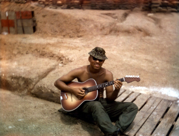 Me & My Guitar - Duc Pho, Montezuma
Seeing Sgt Butler's photo with his guitar struck memories.  Strange thing the photo triggered was that the orange plastic finger twists on the end of the guitar tuners always twisted loose after just a few tunings. Whoever/whatever made those tuner heads must have been in Viet Nam because they were the worst I had EVER seen... and I had seen a LOT of guitars by the time I got there! Anyway, I bought a guitar in Saigon with orange plastic finger twists and cutaway, exactly like the one in the photo. I gave it to one of the guys in the battery and on my next Saigon trip I bought (for just about $2 or $3 more–in "P" of course) another guitar with Japanese tuners on it (they had white plastic tips that never broke). I also left this guitar at the unit when I returned back to "the world." I just wonder if the guitar in the photos was the one I had!


