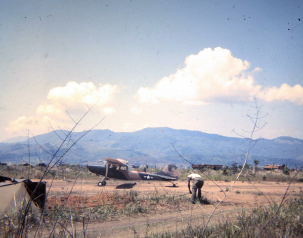 Bird Dog
Bird Dog on the airstrip.  Looks like the soldier in the white tee shirt is running cable.
