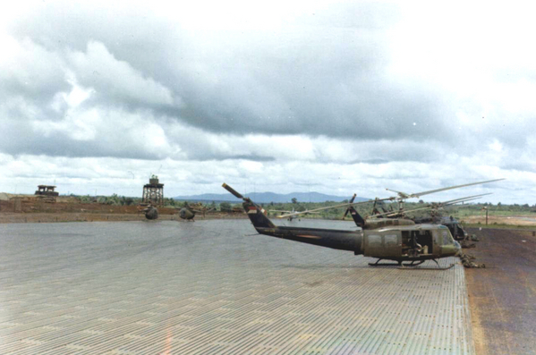 The Slick Park
Dependable Hueys resting on the metal grating serving as a field tarmac.
