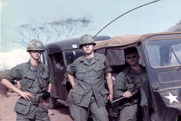 Additional Duty
Everyone had additional duties…even Captains.   Ray Plunkett (RTO), Signal officer Lt Ronald Kettelman and Capt Robert Richardson do village assistance program near Oasis.


