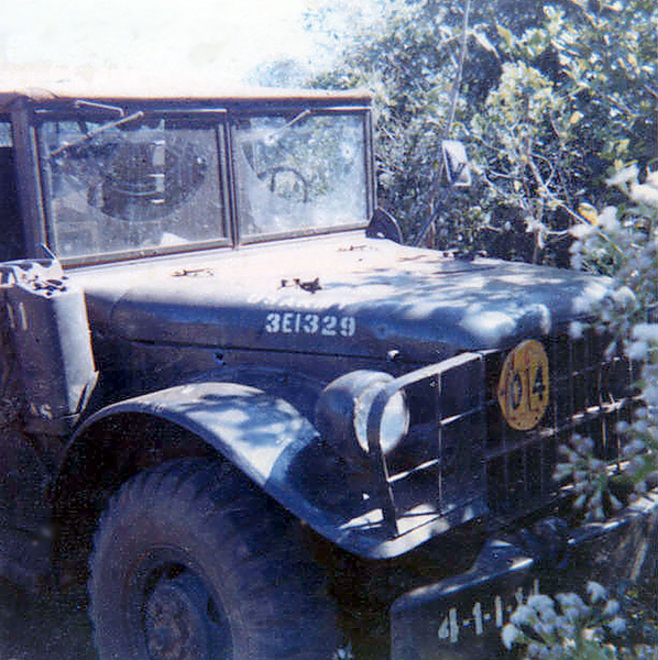 "Humanitarian Truck" gets shot up
This 3/4 ton truck was used for humanitarian purposes to bring medical help and supplies to a local village near one of the firebases.  One day, the guys went in and Charlie was waiting for them and bushwhacked them.  One of the guys was wounded but made it back on foot.  We immediately got the order to go in and kick ass.  We were trucked in and by the time we got there, all that was left was the truck.  If you enlarge the photo, you can see bullet holes in the side frame, the hood, and the windshield.  We cleared the area and got choppered out to another.
