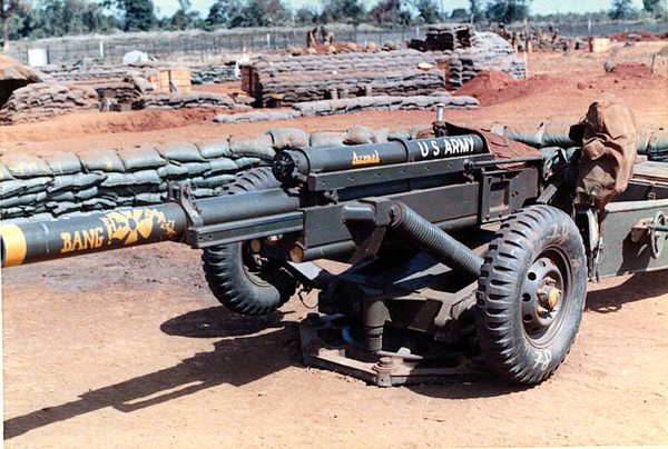 Prior to the wheels coming off
This is a picture of our 105 howitzer before we took off the wheels. They always got in the way and someone was always falling or bumping into them when we swung it around to get it into position!  (Wonder if Ft Sill approved this field modification?)  Paint job by "Mike".
