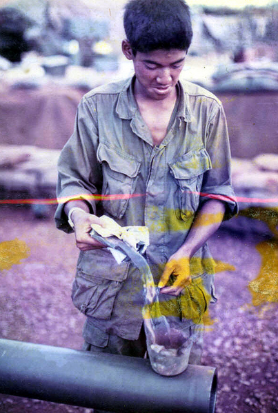 Partially destroyed ammo
Rick explains that some ammo arrived without fuses.  They were told to destroy it with C4 and det cord.  The ammo was stacked pyramid style with C4 stuffed in the fuze hole and wrapped in det cord.  The explosion resulted in a very large piece seen in this photo that landed in the middle of the gun section.  It was fortunate that no one was hurt or killed.  Detonating ammo is a job for the pros, not wannabes.
