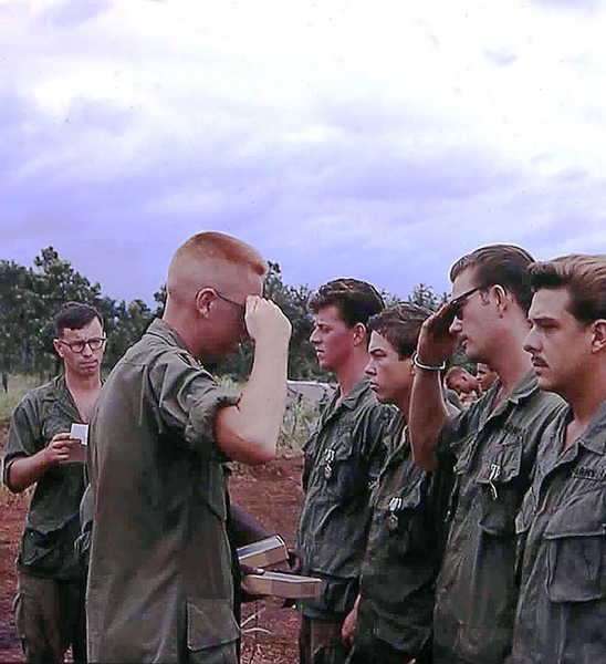 Army Commendation Award Ceremony
Army Commendation Awards ceremony. Getting the medals are: Bill Manton, Danny Fort, Corky, and me. The "crew cut" is very likely Lt Chris Herrick and the background observer wears the "camouflaged black bar" of a 1st Lieutenant, but the name is UNK.
