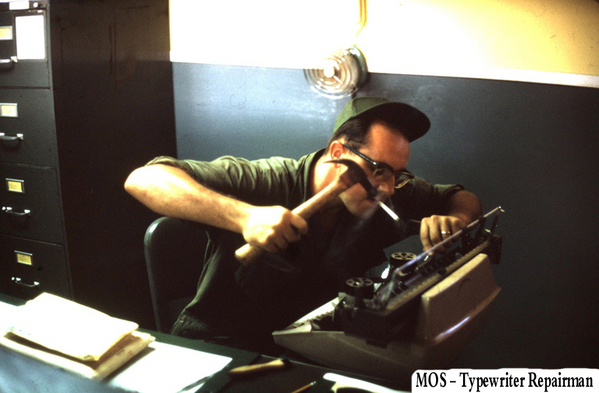 Battery Clerks of the 2/9th Arty
One tap or two? The best way to repair a typewriter.  This is how Sp5 Robert F. Biza repairs his Hq Service Battery typewriter.  Biza's name provided by Sp5 James Keller in November, 2014.  So, now we know.
