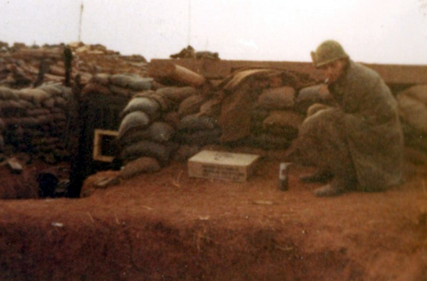 Good Morning, Vietnam!
A "cold day in hell" as they say.  Caesar is warming a bit of hot chocolate just outside the FDC on LZ Incoming.
