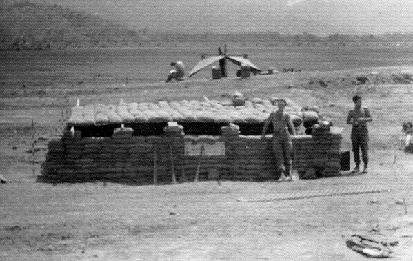 LZ Pony
We hooked out of LZ Meade and landed on an interesting little LZ called "Pony".  LZ Pony was low and flat and adjacent to an airstrip (very adjacent).  There was a rice paddy just north of the LZ.  The photo shows the FDC bunker and the two fellows are George Skulzachek on the left and Greg Malnar on the right.
