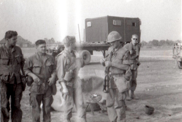 Loading up
Just before we loaded up for our trip to LZ Incoming on the wonderful "Shithooks"!  L to R: Pete Beringer, ____, Ed ____, George Skulzachek (nickname "Caesar"), and Lt George in the background.  Just before this, our CO told us very undiplomatically that some of us would NOT return.  Reason perhaps for the unhappy faces, huh?
