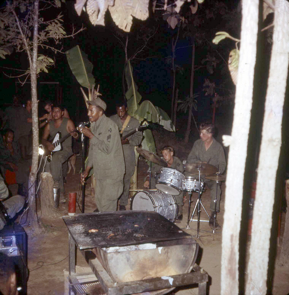 Talent Night in the combat zone
Lots of talent on display here.  {Perhaps he was singing "Running Through The Jungle"?)  Don't ask me where the drums came from!
