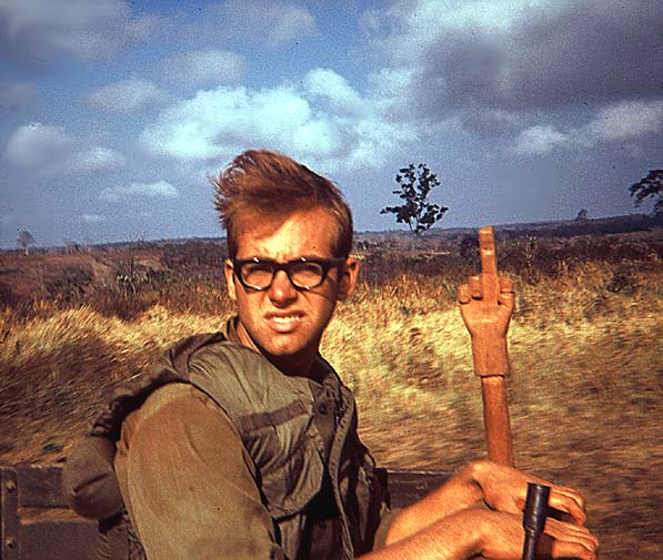 The Fickle Finger of Fate
Rick Algren has a unique backscratcher.  Or, perhaps he was in charge of assigning details.  Actually, it's his "Short Timer's" stick.  Photo taken on a convoy to the Chu Pa mountains, Spring, 1969.
Rick was an RTO before coming into the TOC.
