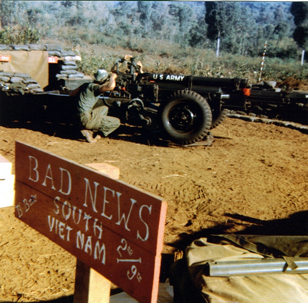 Excellent shot of "B" Battery cannoneers boresighting their howitzer.
