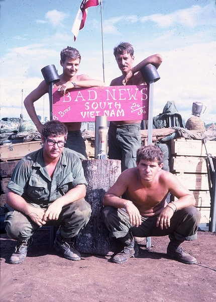 LZ Ranger @ Ban-me-Thuot
All UNKNOWNS!  Anyone have names?  
Sign says: "BAD NEWS" then "SOUTH VIETNAM".  Margin reads "B Btry" on the left and "2/9th" on the right.
