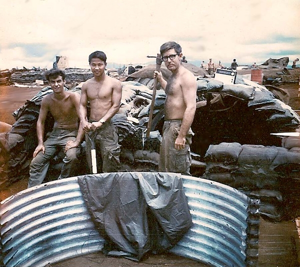 Max T. Leach
Bill Stratton at left, Maximo T. Leach in the center, and Joe Goldstein holding the pickaxe at right.  They may be smiling, but they're tired of filling sandbags.
