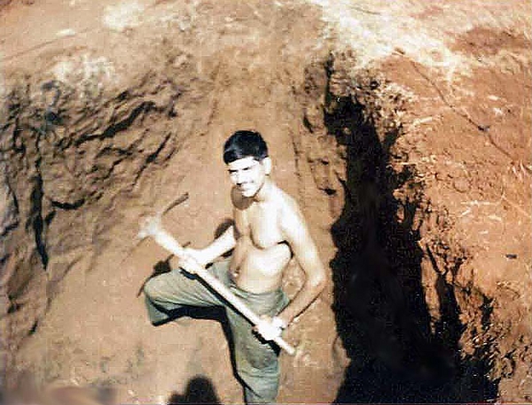 What, me work?
Date: 30 Dec.  Location: LZ Schuyler. 
Would you believe work?  This hole was dug completely for dirt to fill sandbags.  Lots of sandbags.  They told me to look for gold to keep me motivated.
