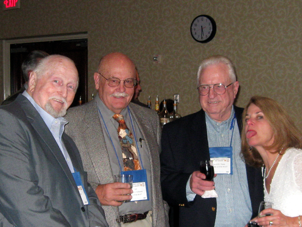 Social hour
Hal Bowling, Art Johnson, David Dunn and wife Chris Dunn enjoy a little libation before the Saturday dinner.  Chris' legacy is to stick out her tongue at the cameraman...just like last year.
