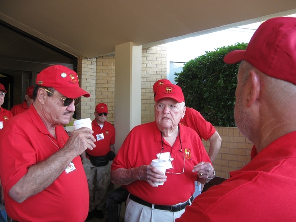 Arrival
A sea of red 2/9th FA shirts outside Allin Hall.  Mike Kurtgis and Jerry Orr seem to be wondering, "Who the hell made this coffee??"
