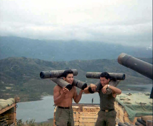 Unique carry
Carlos Casteel and Freddie Martinez bear the load from the ammo dump to the gun emplacements.
