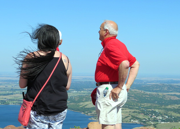 Mt Scott
A great view, but it felt like a hurricane was blowing!
Sam Nieto (in front of his daughter) is deceased, as is Wayne Crochet, wearing his "Artillery Red" shirt.  Wayne had to put his cap in his pocket due to the high winds.

Photo courtesy of Barbara Moeller
